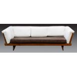 A George Nakashima for Widdicomb even-arm sofa, executed in walnut, having slat ends, continuing