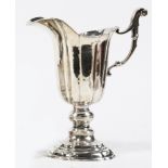 A George III sterling pitcher, William Ward, Dublin, circa 1793, the ribbed helmet form rising on