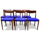A group of Danish Modern teak dining chairs, each having blue cobalt upholstery, and rising on