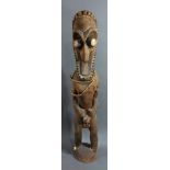 A Vanuatu standing figure, Namba people, Malekula, executed in wood with a classic concave face on a