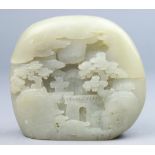 A Chinese carved white jade boulder, carved in relief and deeply undercut a pine tree-surrounded