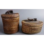 (lot of 2) Indonesian Lomdak lidded baskets, with carved wood figural finials, largest: 7.5"h