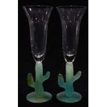 A pair of Daum "Cactus" pate de verre glass and crystal champagne flutes, each having a clear bowl