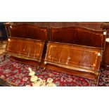 Pair of Louis XVI marquetry decorated rosewood twin beds, consisting of headboard, footboard, and