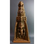 A Papua New Guinea canoe prow, having incised decoration of stylized figures, one having a