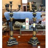 Pair of Neoclassical partial gilt candelabra, each having four arms with gilt bronze mounts, and