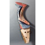 A Solomon Islands canoe prow, of dramatically abstracted and artful bird form, decorated with