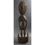 A Papua New Guinea hook figure with incised carving, 33.5"h; Provenance: Richard I.M. Kelton