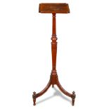 A Federal style mahogany plant stand, having shaped top, above a baluster form fluted standard and