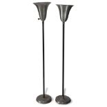 Pair of Russel Wright aluminum floor lamps, having a tapered shade and rising on a circular base,