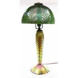 A Lundberg Studios table lamp, having a domed shade in green, above a tapered standard executed in