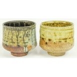 (lot of 2) Studio stoneware footed tea bowls with blue or gold drip glaze