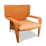 A Mid-Century Modern style orange upholstered lounge chair