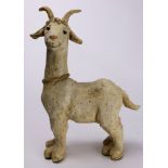 Whimsical white clay figure of a goat with a cowbell