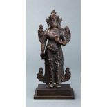 A Sino-Tibetan cast bronze figure of a standing crowned Buddha