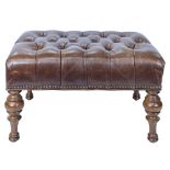 A Victorian style leather ottoman