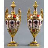 A pair of Royal Crown porcelain urns