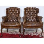 A pair of Georgian style wing chairs