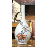 A long neck Chinese enameled vase, of compressed globular body shape and painted with leafy peaches.