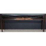 A contemporary glass and patinated metal console table, the frosted glass inset glass resting on the