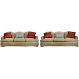 Pair of Moderne golden/red upholstered sofas, each having a shaped back, above three seats, 34"h x