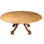 A Therien Studio Volute walnut circular dining table in the Italian Rococo style, the outset round