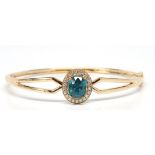 Blue zircon, diamond, 14k yellow gold bracelet Featuring (1) oval-cut blue zircon, weighing