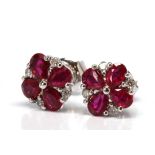 Pair of ruby, diamond, 14k white gold earrings Featuring (8) pear-cut rubies, weighing a total of