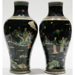 (lot of 2) A Pair of Chinese black ground Famille-rose vases, each painted with figures in a