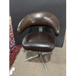 A Mid Century adjustable office chair, covered in brown upholstery and having a chrome adjustable