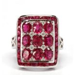 Ruby, diamond, 14k white gold ring Centering (9) oval-cut rubies, weighing a total of