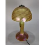 Lundberg Studios lamp, having a gold aurene shade, above a confirming ribbed base, signed and