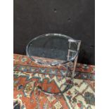 Eileen Gray adjustable table, executed in tubular steel and having a glass top, 25''h x 19.5''w