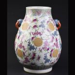 Chinese enameled porcelain vase, the body painted leafy peaches and bats and flanked by a pair of