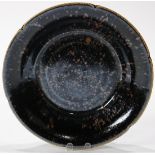 A Chinese Russet Splashed Black 'Partridge Feather' Dish, Of foliate form supported on a flattened