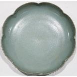 A Chinese celadon dish, of lobed " flower" shape and overall applied with celadon glaze, a three-