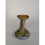 A Louis Comfort Tiffany favrile candlestick, having an iridescent body with a large bobeche,