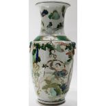 A Chinese famille-vert vase, depicting figures under the rocks and pine trees, flanked by a pair