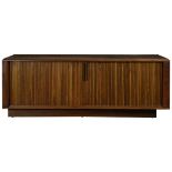 A Mid Century low credenza, the rectangular form having tambour doors and rising on a molded base,