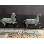 A pair of Marino Marini style Modern horse sculptures, each having a verdis finish with a front