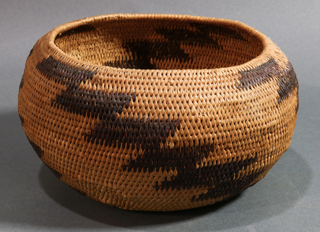 A Pomo Native American Indian single rod coiled basket, Northern California, having a slightly