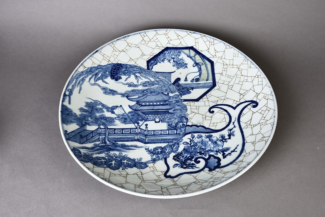 A Chinese export blue and white porcelain charger depicting ancient pagoda in a landscape scenery.