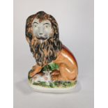 English Staffordshire figure of a lion and a lamb, the lion having a molded and painted body, 10.5"
