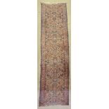 An antique Persian Sarouk runner, 2'8" x 12'10"