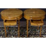 A pair of Biedermeier style occasional tables, each having a circular top above the conforming