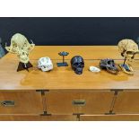 (lot of 7) A group of decorative skull models, most in resin, one in candle form depicting a