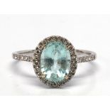 Tourmaline, diamond, 18k white gold ring Centering (1) oval-cut blue tourmaline, weighing