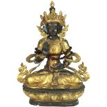 A Nepalese gilt copper alloy figure of Dhyani Buddha, a seated figure on lotus pedestal with right