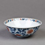 A Chinese blue and copper red bowl, featuring scrolling foliate tendrils accompanied by flowers