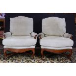 A pair of Gina B of Los Angeles custom lounge chairs, each having loose cushions and rising on
